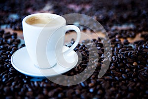 Cup of coffee and coffee beans on wooden vintage table