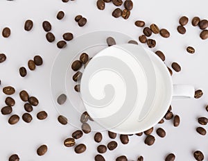 Cup of coffee with coffee grains on a light background