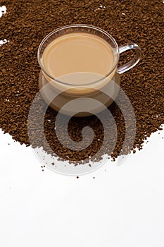 Cup of coffee and coffee powder as background