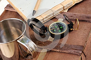 Cup of coffee with compass and notepad