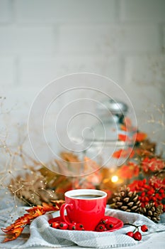 Cup of coffee, cones and autumn leaves on a wooden table. Autumn background.