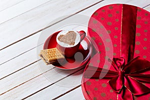 Cup of coffee, cookie and gift