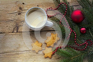 Cup of coffee with cookies in star shape and fir branches with c