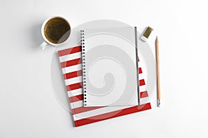 Cup of coffee with copybooks and pencil on white background