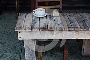 The cup of coffee costing on a wooden little table, a cappuccino, coffee with milk, fragrant a cappuccino.