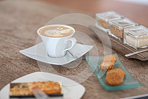 Cup of coffee cup with crunchy cookie on the table