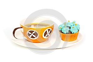 Cup of coffee and cupcake with blue cream frosting