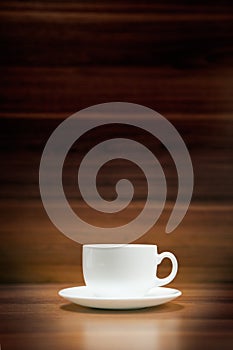 Cup of coffee on dark wood background
