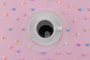 A cup of coffee decorate with pastel heart pattern