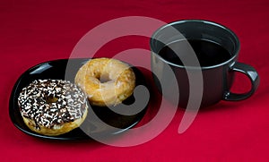 Cup of Coffee with Donuts on a Red Table Cloth