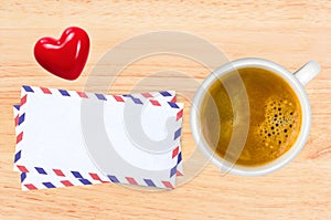 Cup of coffee and envelops on wooden table