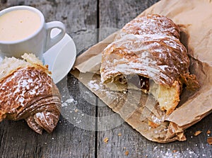 A cup of coffee espresso and croissant