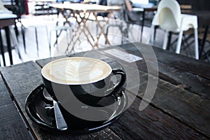 A cup of coffee at the eye view on wood table