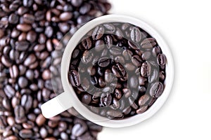 Cup of coffee filled with coffee beans isolated on white background