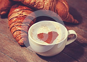 Cup of coffee with french croissant