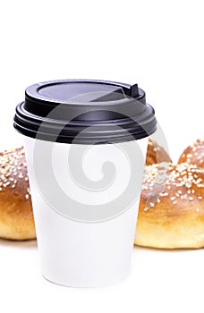 A cup of coffee and fresh buns pastry isolated on a white background