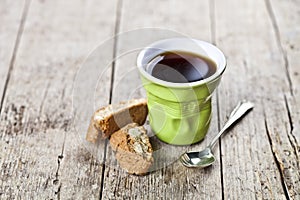 Cup of coffee, fresh Italian cookies cantuccini with almond seeds on ructic wooden table background