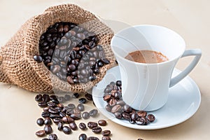 Cup of coffee and fresh roasted organic Coffee beans