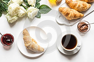 Cup of coffee and freshly baked croissants. Top view. Female breakfast