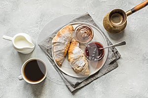 Cup of coffee, freshly baked croissants. Top view. Flat lay. Concept french breakfast