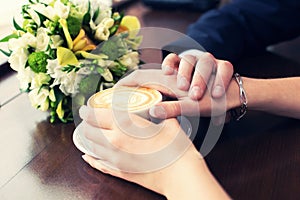 Cup of coffee and hands newlywed