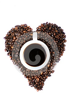 CUP OF COFFEE IN HEART SHAPED COFFEE BEANS