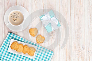 Cup of coffee, heart shaped cookies and gift box