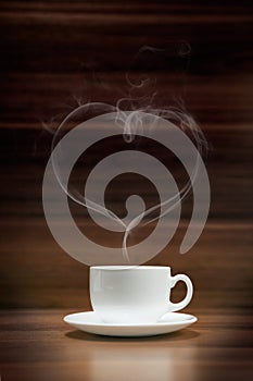 Cup of coffee with heart-shaped smoke