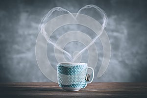 Cup of coffee with a heart shaped steam