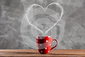 Cup of coffee with a heart shaped steam