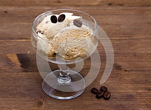 Cup of coffee ice cream on wood