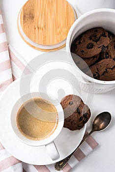 Cup of coffee and jar of chocolate cookies