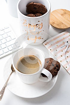 Cup of coffee and jar of chocolate cookies