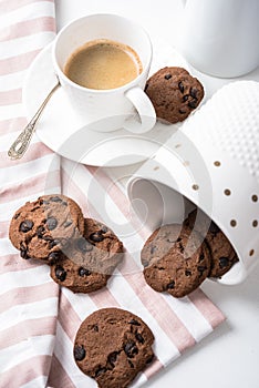 Cup of coffee and jar of chocolate cookies