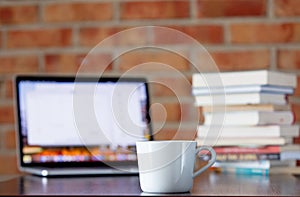 Cup of coffee and laptop computer on a table