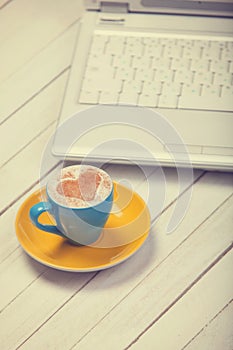 Cup of coffee and laptop
