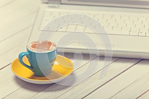 Cup of coffee and laptop