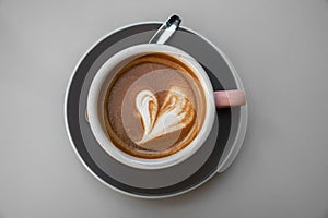 Cup of coffee with a latte art heart design at a cafe in San Sebastian, Spain