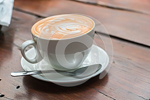 A Cup of coffee with latte art in hearth shape in white coffee c