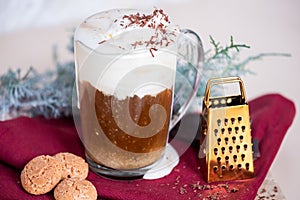 Cup of coffee latte, cookies and cade branch in Christmas mood. Copy Space