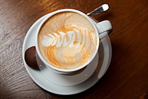 A cup of coffee. Latte with a pattern in a white cup