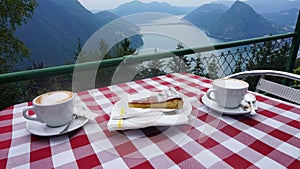 Cup of coffee and lemon pie on the table. Cafe on Mount Monte Bre.