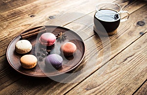 Cup of coffee and macarons with cinnamon and onyx