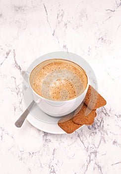 Cup of coffee on a marble background. Perfect cappuccino, hot chocolate, latte coffee and cookies, top view.