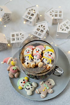 Cup of coffee with marshmallows. Marshmallow snowman in a Santa Claus hat. Winter drink. Christmas sweet food. Top view