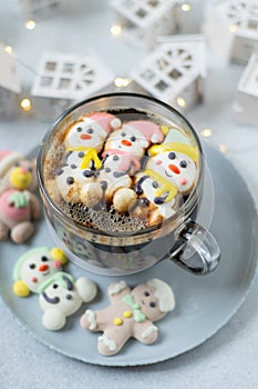 Cup of coffee with marshmallows. Marshmallow snowman in a Santa Claus hat. Winter drink. Christmas sweet food. Top view