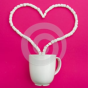 Cup of coffee and marshmallows on pink background. Heart. Flat lay. Top view