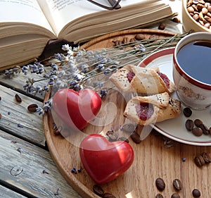 A cup of coffee with marshmallows on a wooden tray