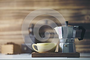 Cup of coffee with metal coffee percolator