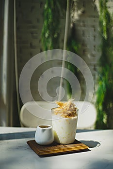 Cup of coffee with milk and sweet silk candy